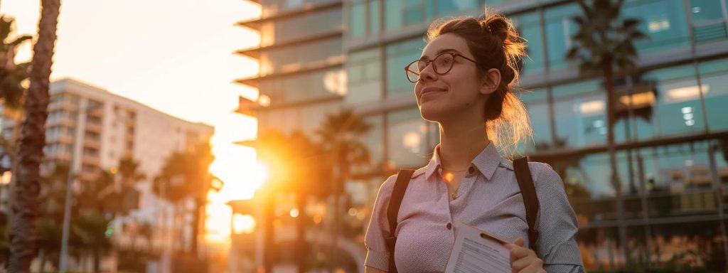 a determined worker stands confidently in front of a modern office building in long beach, clutching essential claim forms while a warm sunrise illuminates the scene, symbolizing hope and the journey towards justice in workers' compensation claims.