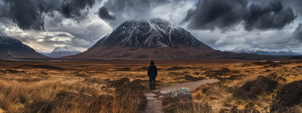 a determined individual stands resolutely in front of a vast mountain landscape under a dramatic sky, symbolizing the journey of overcoming the challenges of a denied insurance claim and seeking new solutions.